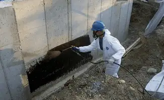 Professional waterproofing the exterior walls of the basement in Tulsa, OK
